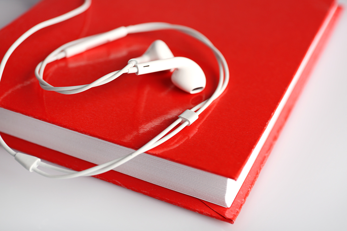 Earphones and Book on a Table